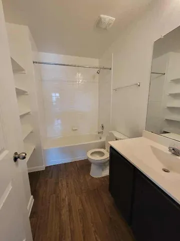 a bathroom with a double vanity sink toilet and shower