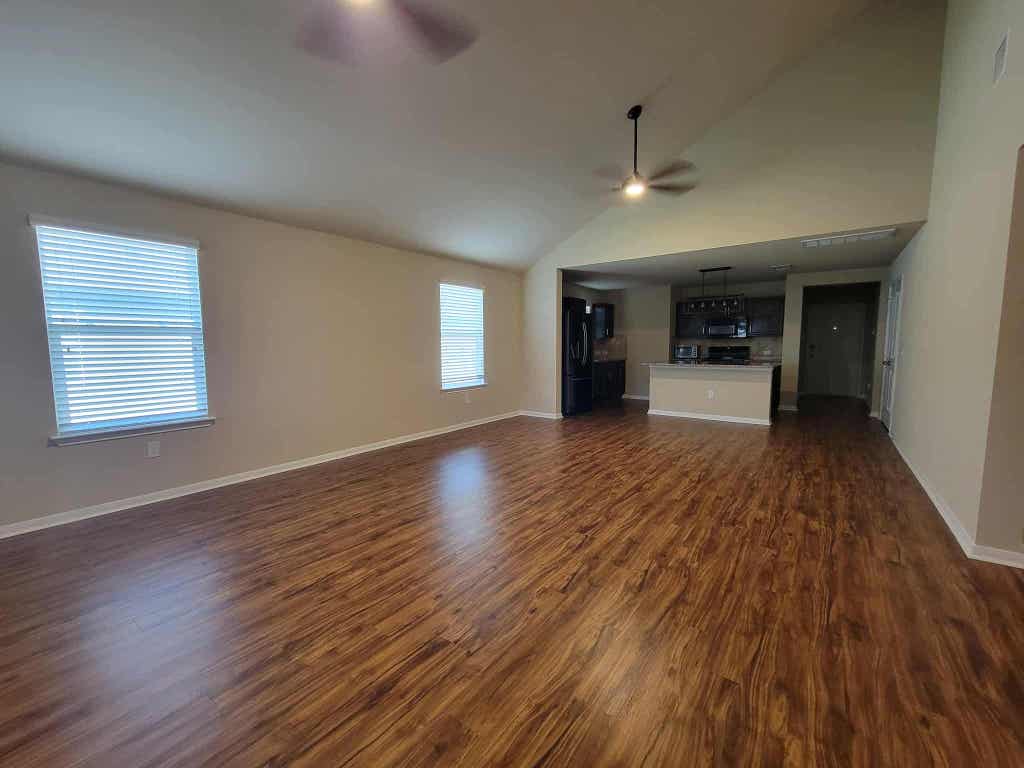 213 Camellia Drive Hutto, TX 78634 - Photo 21 of 27 a view of a room with wooden floors and lots of windows