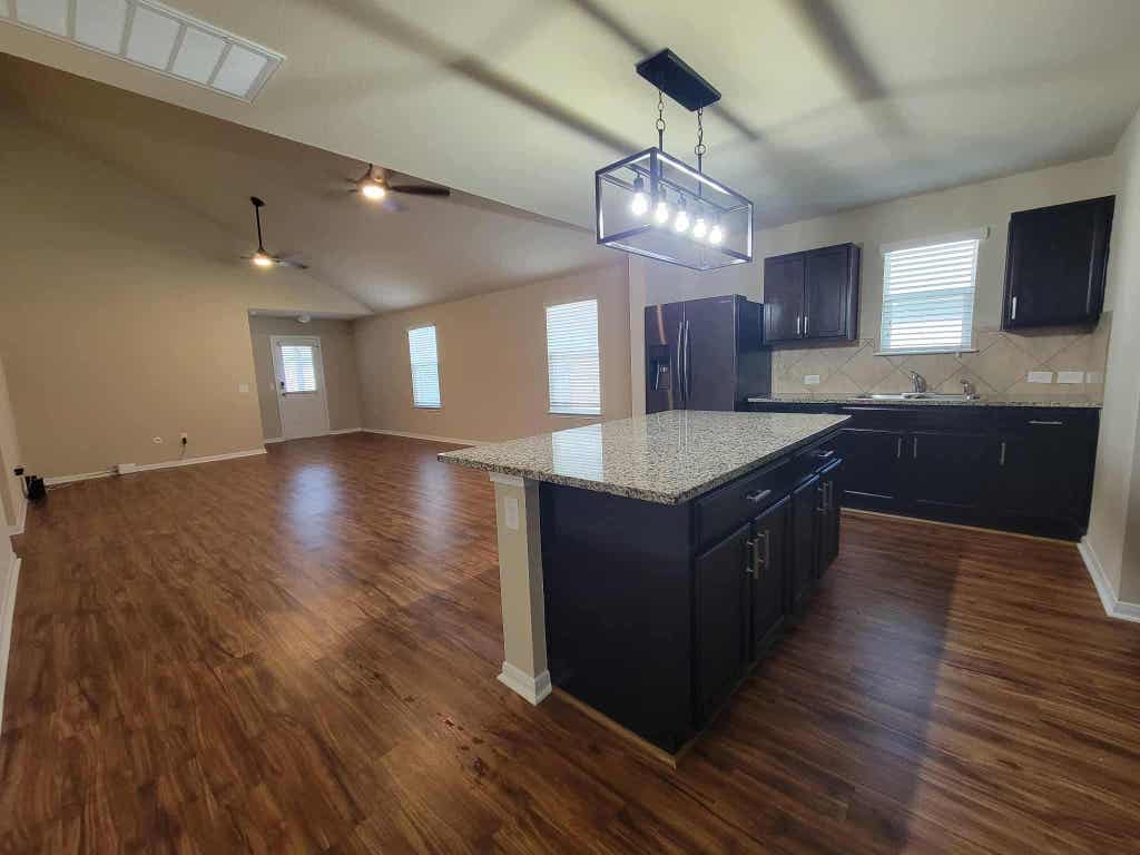 213 Camellia Drive Hutto, TX 78634 - Photo 7 of 27 a large hall with wooden floors and chandelier