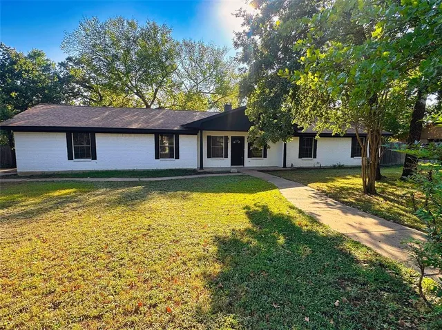 a house view with swimming pool in front of it
