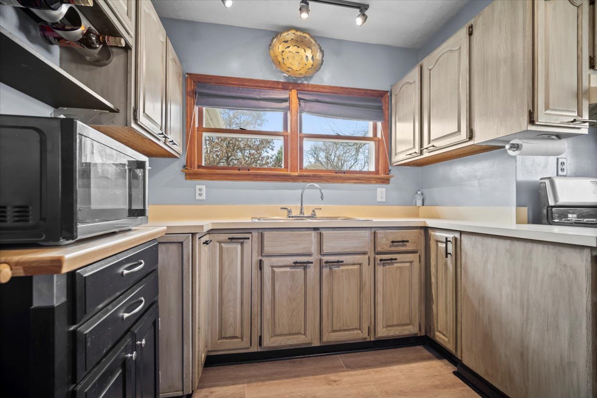 914 Normal Avenue Normal, IL 61761 - Photo 6 of 23 a kitchen with stainless steel appliances granite countertop a sink and cabinets with wooden floor