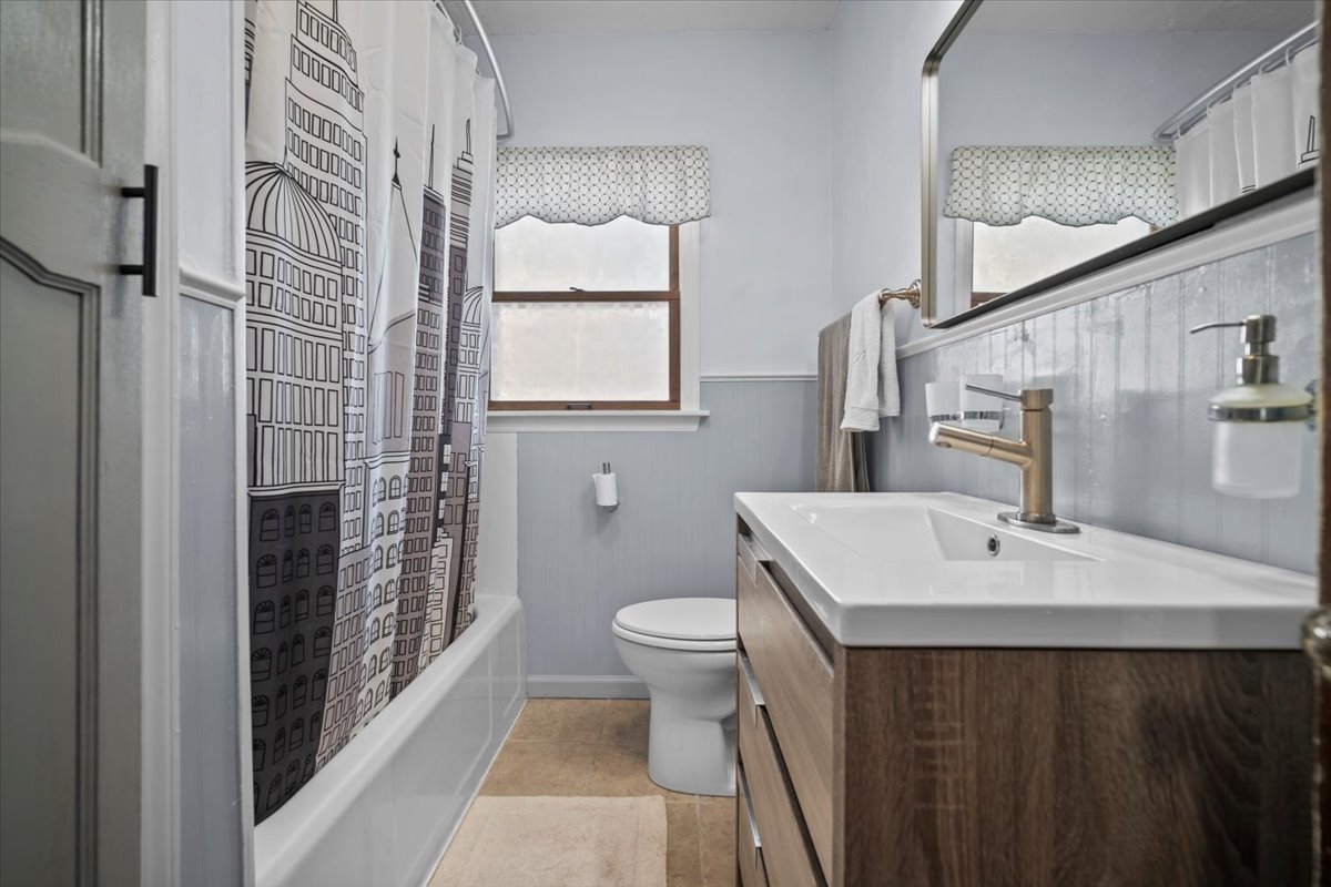 914 Normal Avenue Normal, IL 61761 - Photo 9 of 23 a bathroom with a sink a toilet and shower