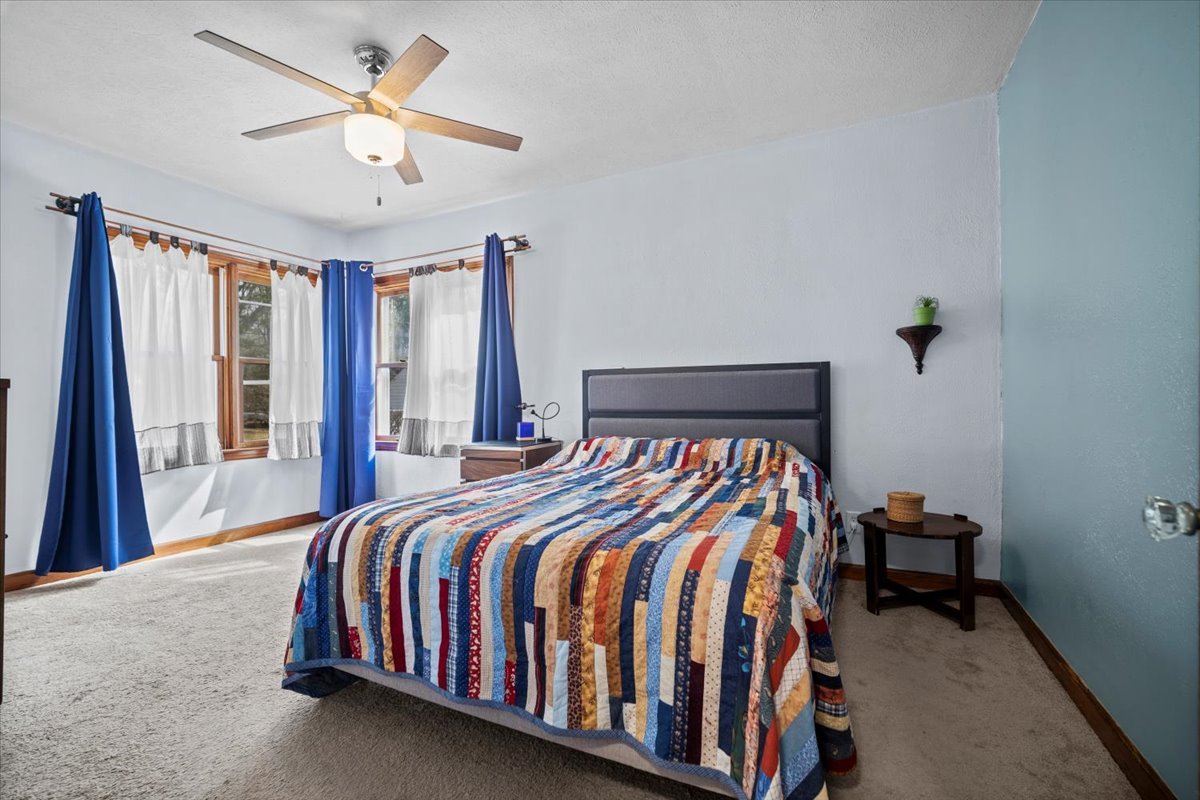 914 Normal Avenue Normal, IL 61761 - Photo 10 of 23 a bedroom with a bed and a chandelier