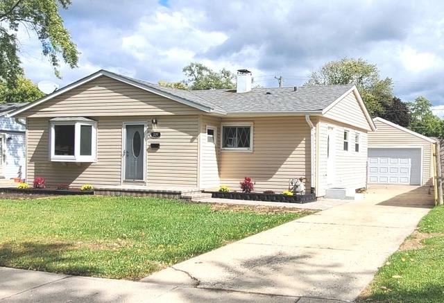 329 Fletcher Drive Wheeling, IL 60090 - Photo 1 of 16 a front view of a house with a yard and garage