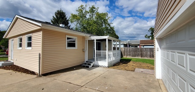 329 Fletcher Drive Wheeling, IL 60090 - Photo 15 of 16 a view of a small house with wooden fence