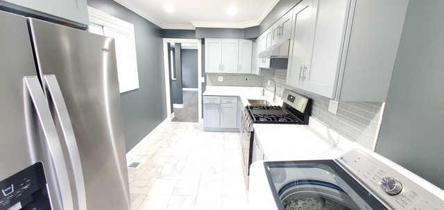 329 Fletcher Drive Wheeling, IL 60090 - Photo 6 of 16 a kitchen with stainless steel appliances a refrigerator and a stove