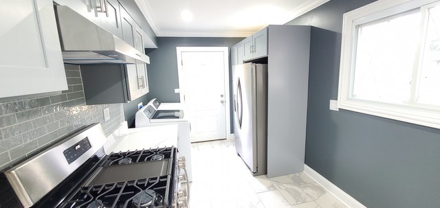 329 Fletcher Drive Wheeling, IL 60090 - Photo 7 of 16 a kitchen with stainless steel appliances granite countertop a refrigerator and a stove