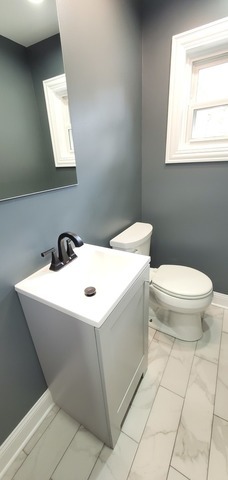 329 Fletcher Drive Wheeling, IL 60090 - Photo 8 of 16 a bathroom with a sink a toilet and mirror