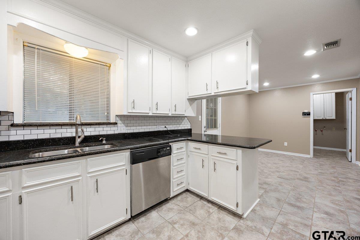 133 Caroline Street Rusk, TX 75785 - Photo 11 of 21 a kitchen with granite countertop a sink and a stove