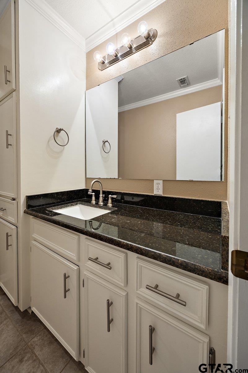 133 Caroline Street Rusk, TX 75785 - Photo 17 of 21 a bathroom with a granite countertop sink and a mirror