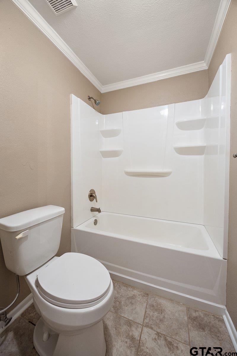 133 Caroline Street Rusk, TX 75785 - Photo 18 of 21 a white toilet and tub sitting next to a bathroom sink