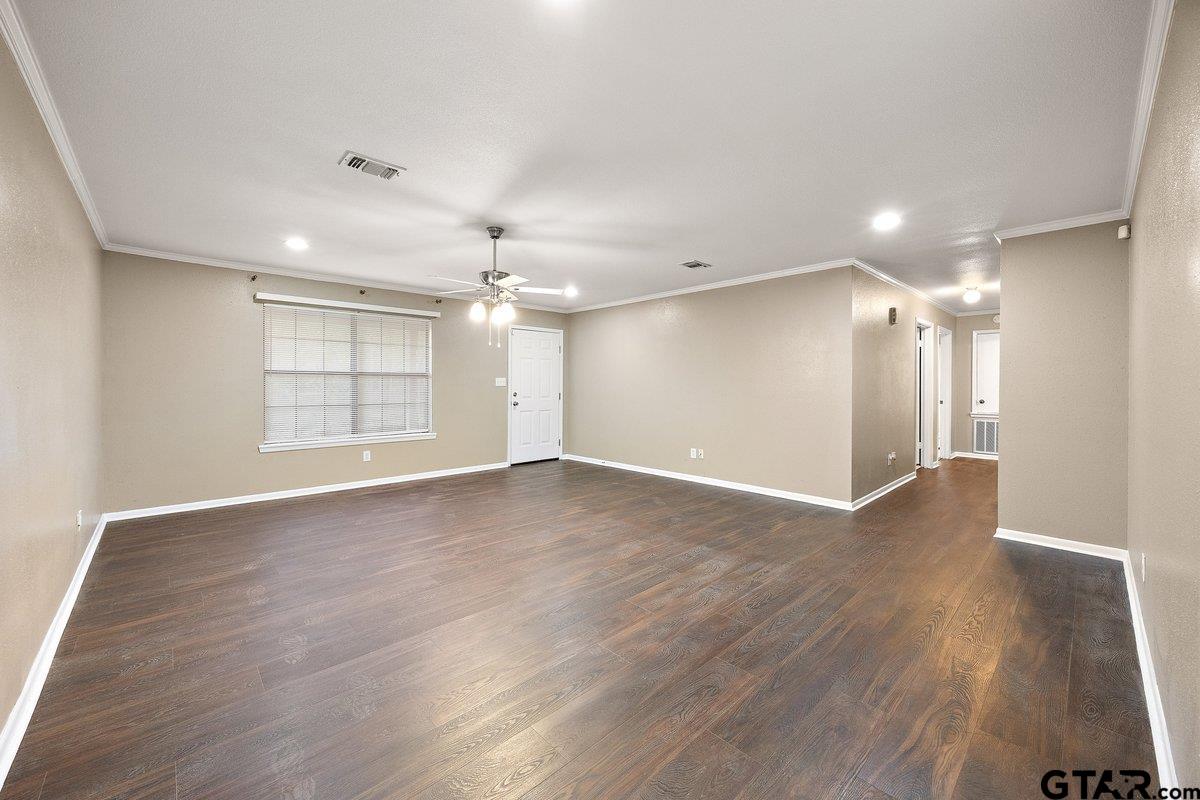 133 Caroline Street Rusk, TX 75785 - Photo 7 of 21 an empty room with wooden floor and windows