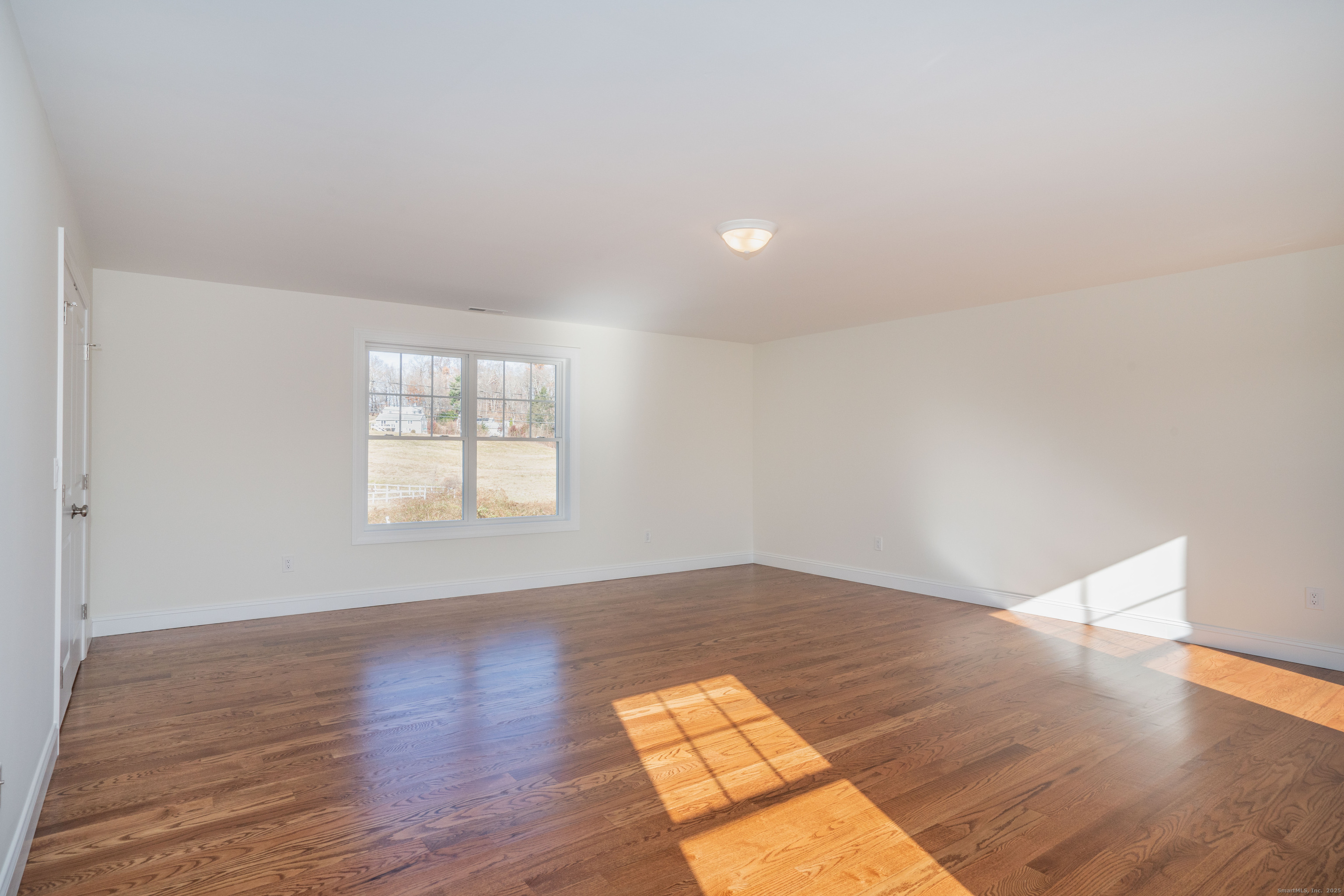 975 High Road Berlin, CT 06037 - Photo 15 of 35 an empty room with wooden floor and windows