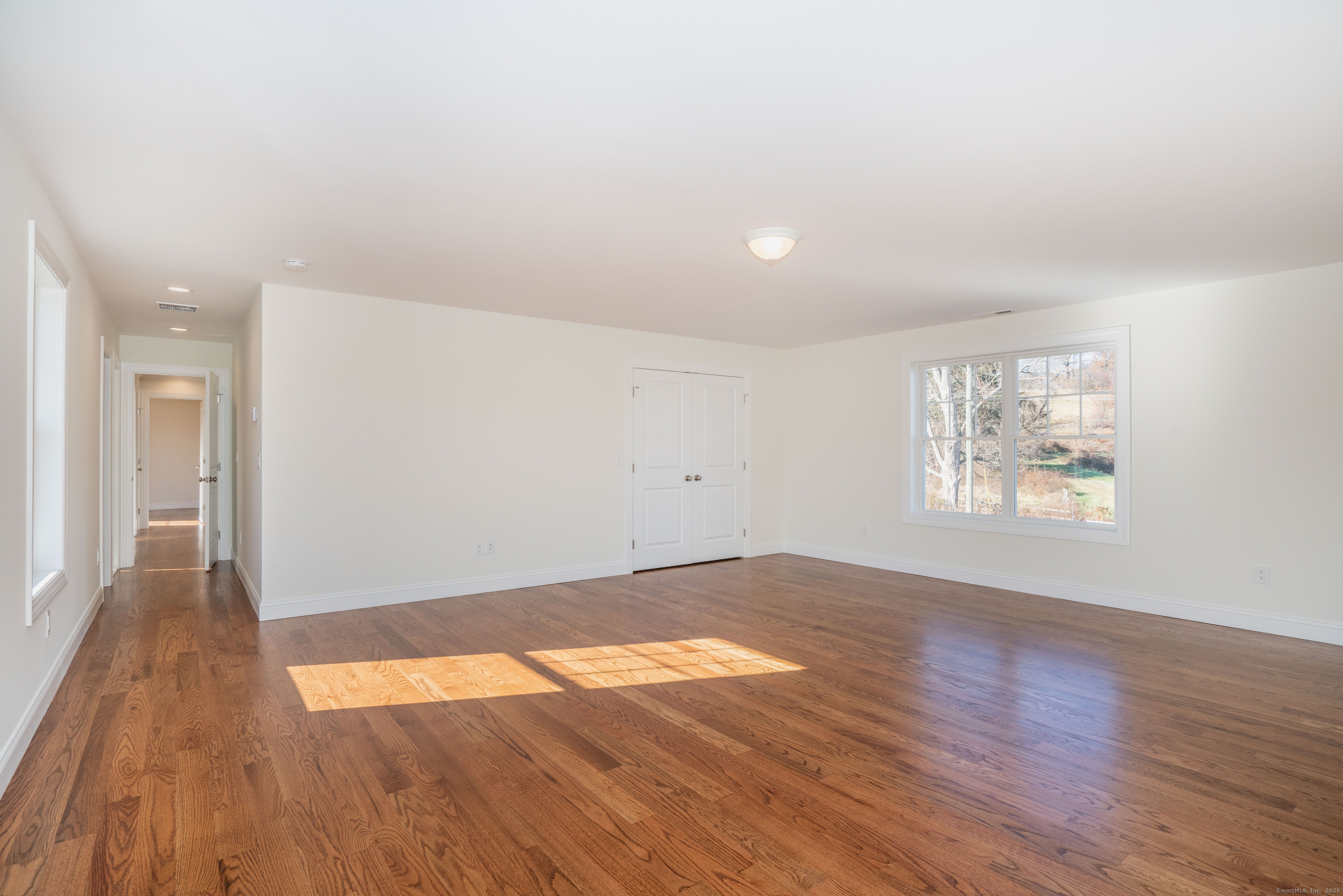 975 High Road Berlin, CT 06037 - Photo 16 of 35 an empty room with wooden floor and windows