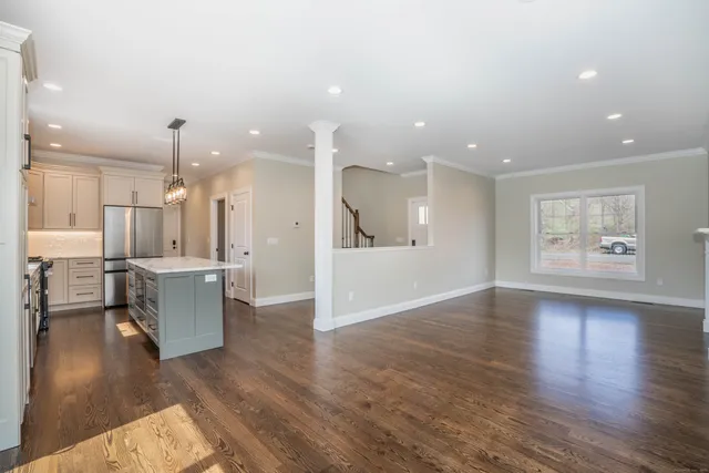 a view of a living room and kitchen with hardwood floor