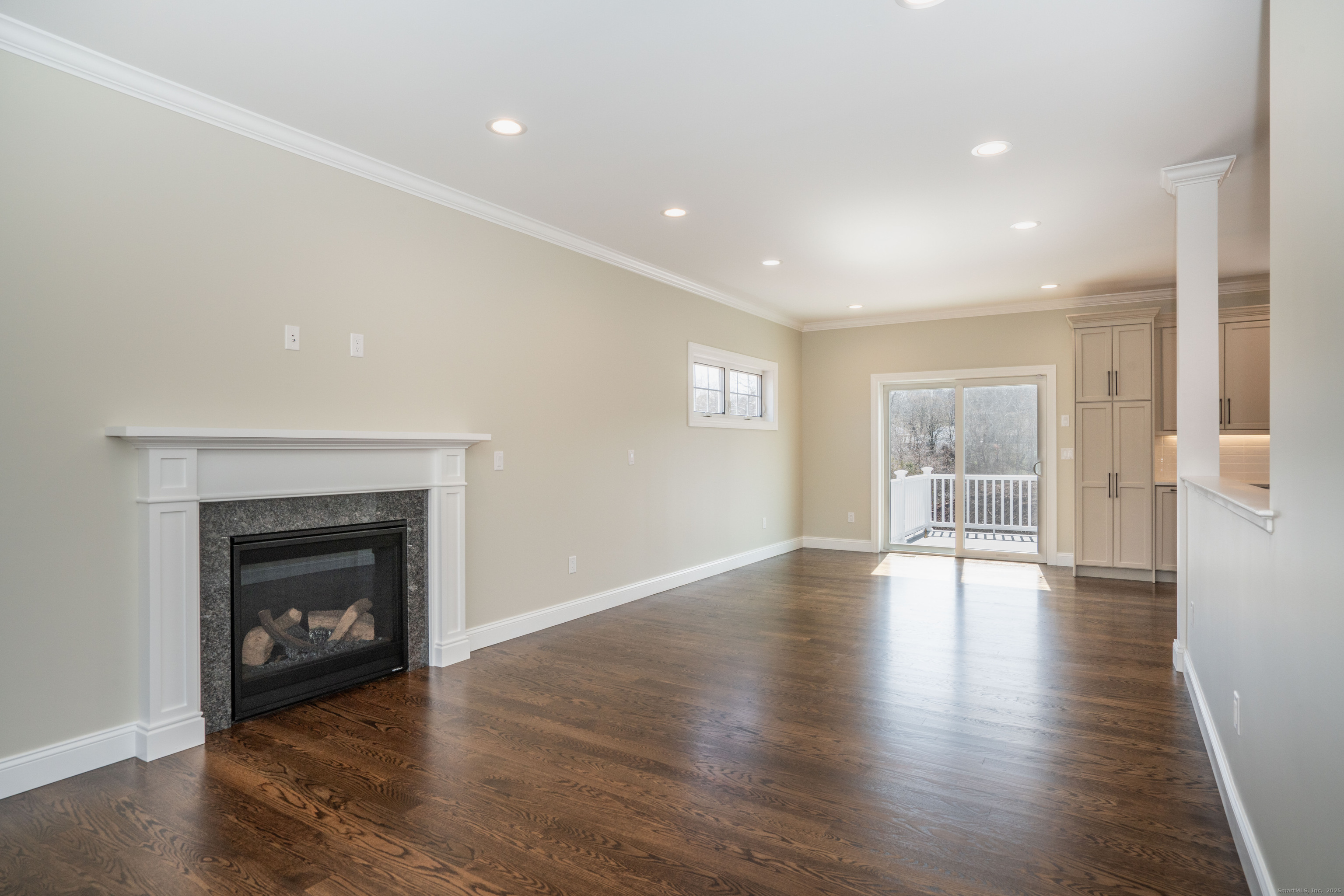 975 High Road Berlin, CT 06037 - Photo 23 of 34 a view of an empty room with wooden floor fireplace and a window