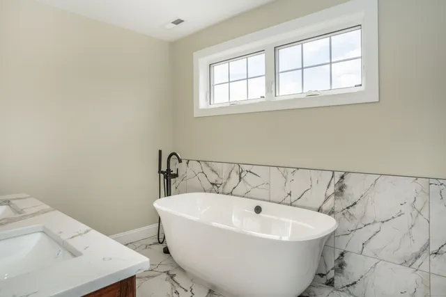 a white bath tub sitting in a bathroom