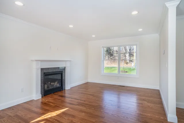 an empty room with windows and a fireplace