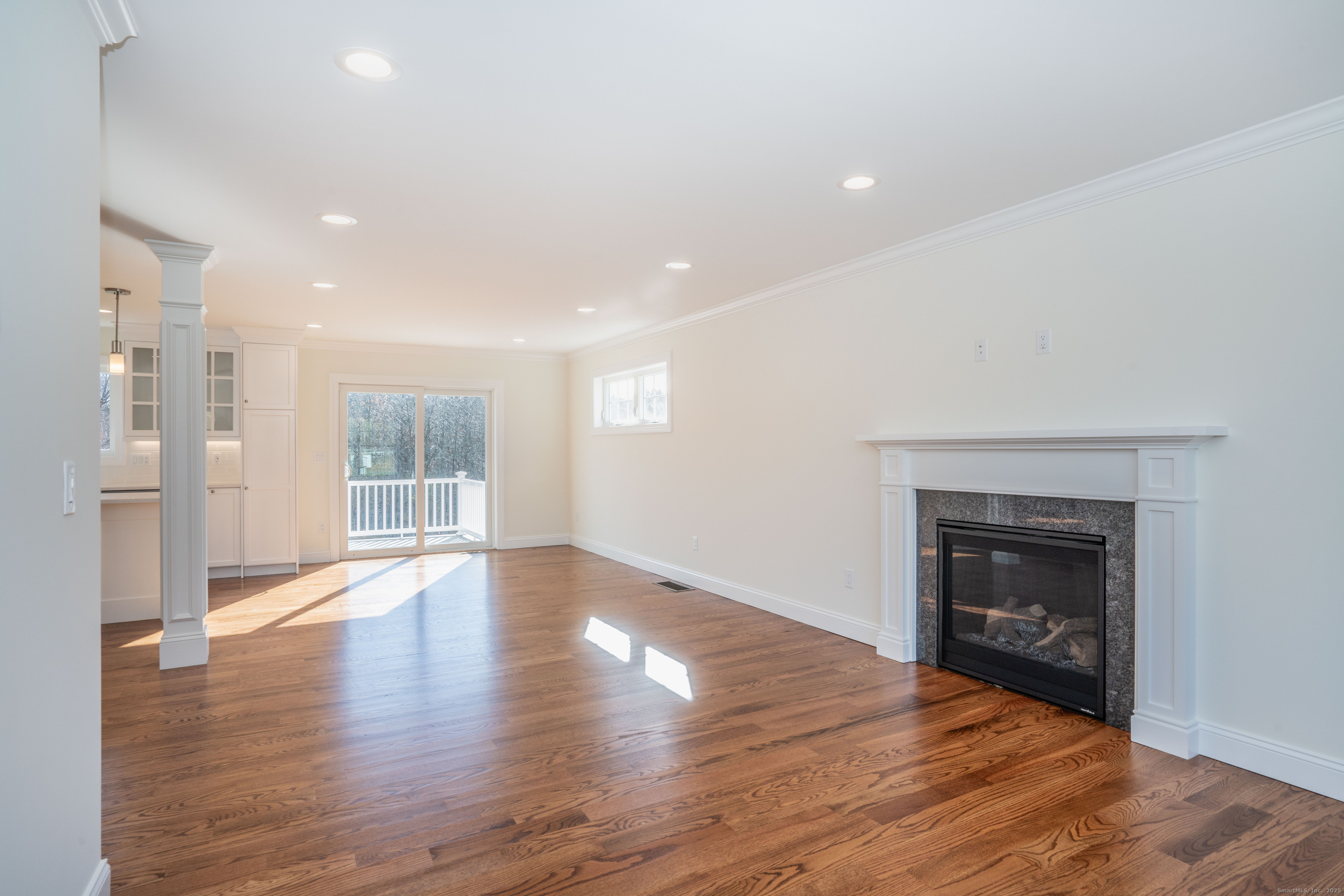 975 High Road Berlin, CT 06037 - Photo 6 of 34 a view of an empty room with wooden floor fireplace and a window