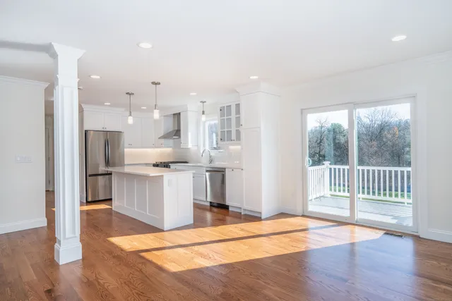 a view of a kitchen with wooden floor and a window