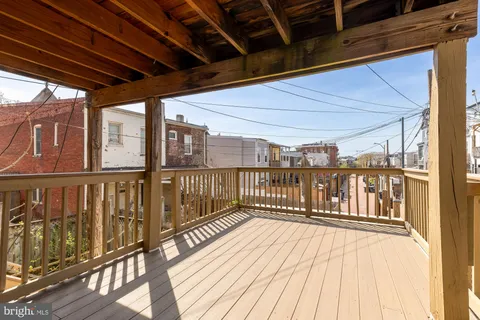 a view of a balcony with wooden floor