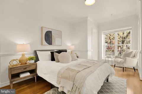 a bedroom with a bed and a chair