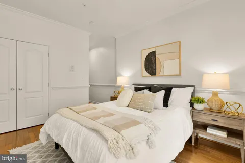 a bedroom with a bed and lamp