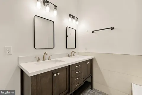 a bathroom with a double vanity sink and mirror