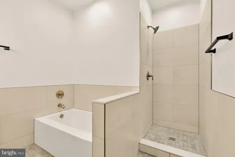 a bathroom with a shower and mirror