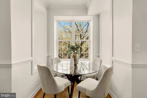 a view of a dining room with furniture and a window