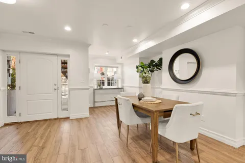a view of a kitchen area with furniture and wooden floor