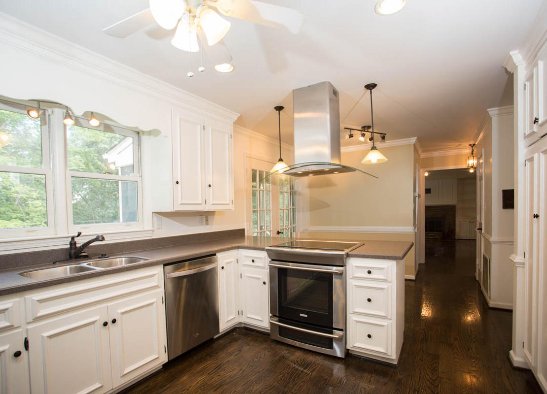 5135 Falcon Ridge Road Roanoke, VA 24018 - Photo 13 of 56 a kitchen that has a lot of cabinets in it and wooden floors