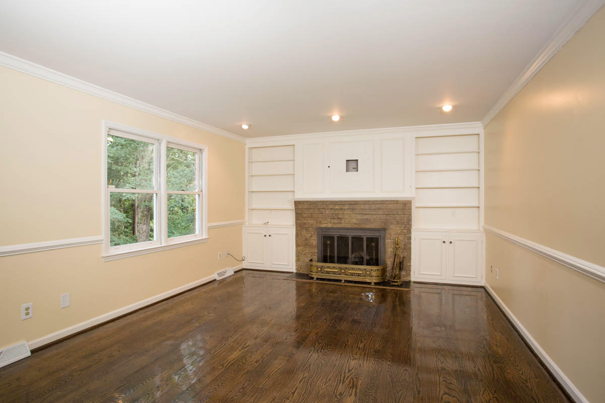 5135 Falcon Ridge Road Roanoke, VA 24018 - Photo 17 of 56 an empty room with wooden floor fireplace and windows