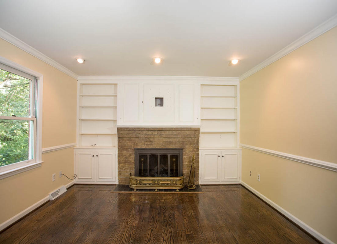 5135 Falcon Ridge Road Roanoke, VA 24018 - Photo 18 of 56 an empty room with wooden floor fireplace and windows