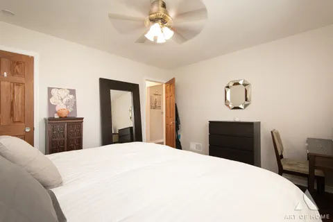 a bedroom with a bed and a chandelier