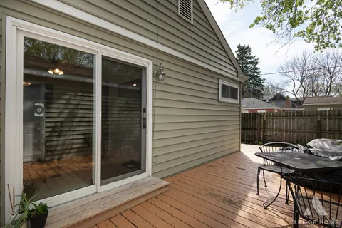 a backyard of a house with barbeque oven and outdoor seating
