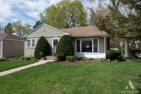 a view of house with a yard