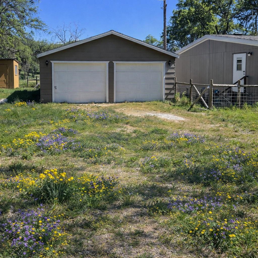 33831 Medford Road Auberry, CA 93602 - Photo 26 of 35 a view of a backyard with plants and a large tree