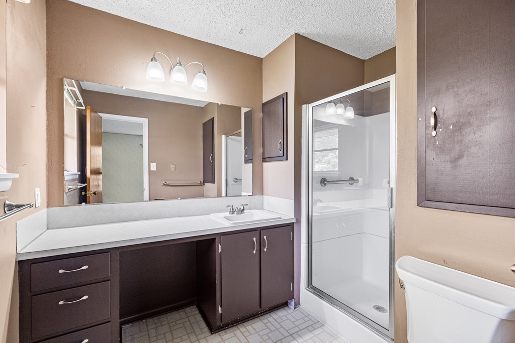 168 Stoney Hills Road Center Point, TX 78010 - Photo 19 of 32 a bathroom with a double vanity sink and mirror with shower