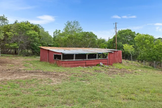 a barn in the middle of a yard