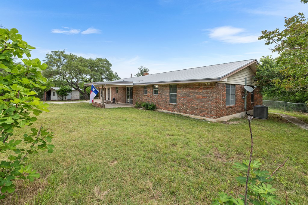 168 Stoney Hills Road Center Point, TX 78010 - Photo 9 of 32 a view of a house with a yard and sitting area