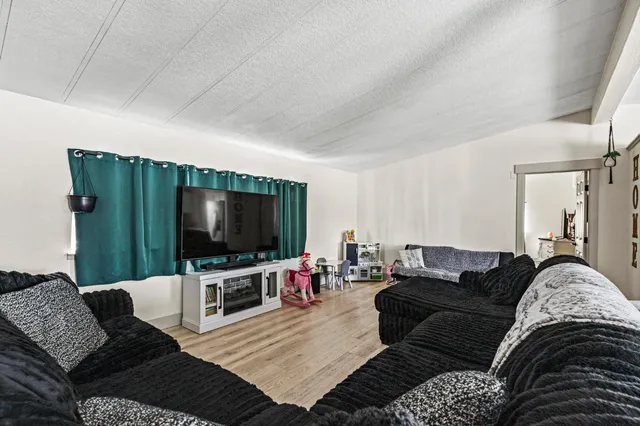 a kitchen with white cabinets and refrigerator