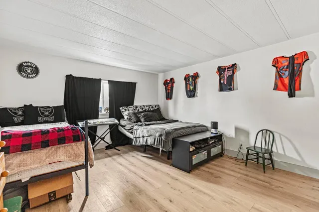 a bedroom with two beds and a flat screen tv