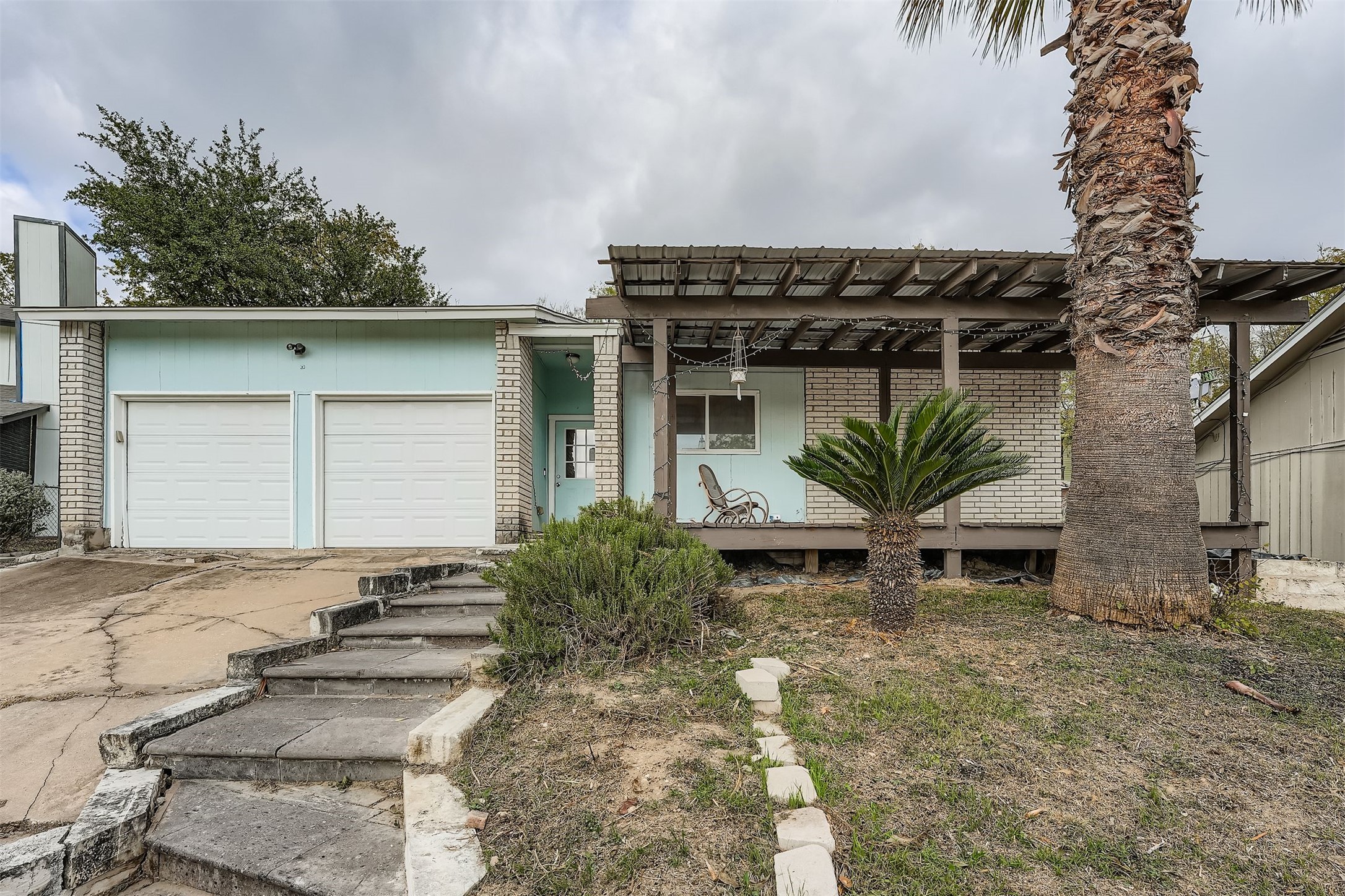 4902 Parell Path Austin, TX 78744 - Photo 1 of 1 a backyard of a house with plants and outdoor seating