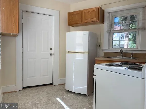 a kitchen with a refrigerator and a stove