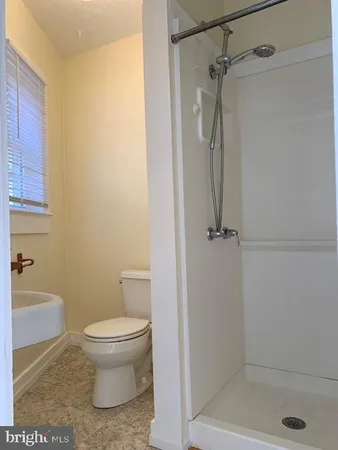a bathroom with a shower and a toilet