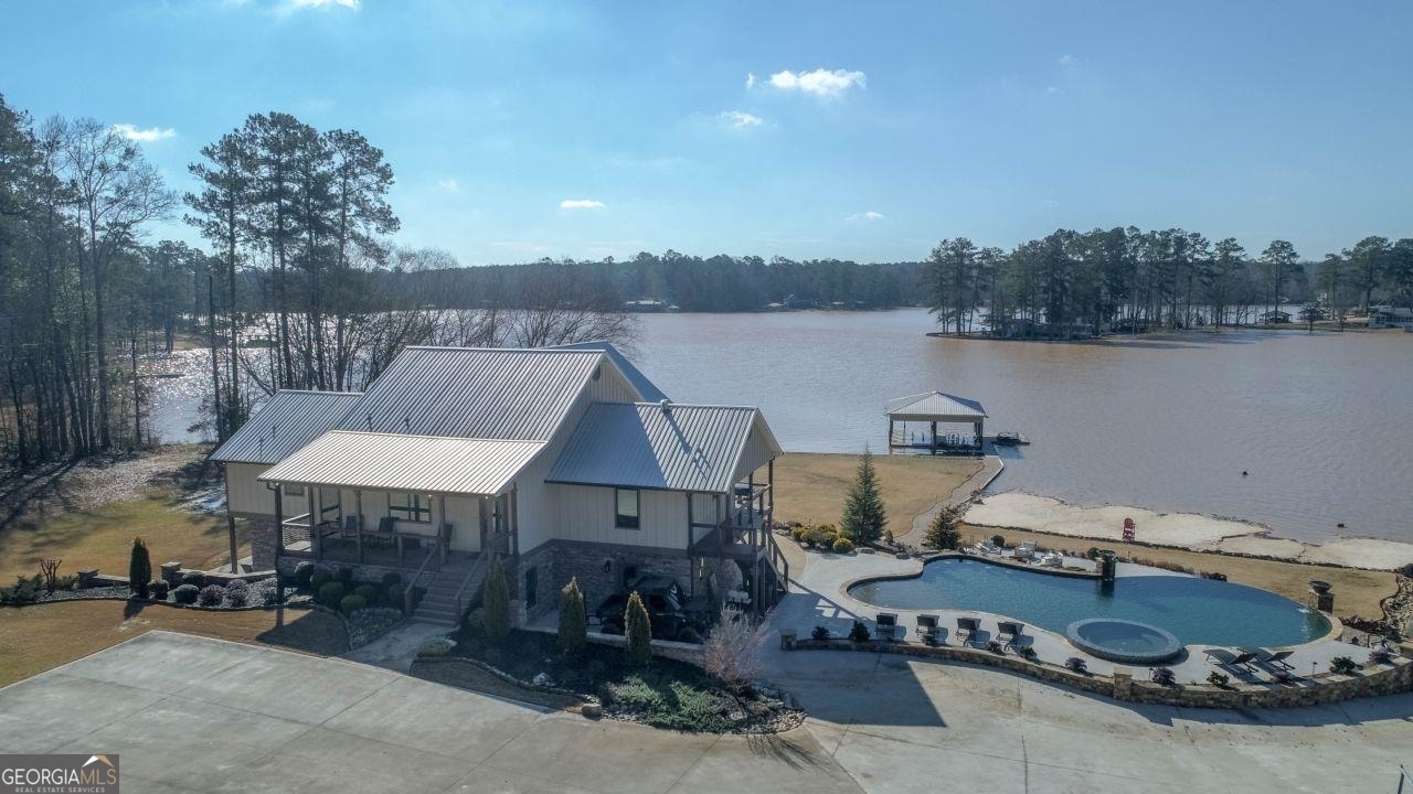 a aerial view of a house with lake view and a floor to ceiling window
