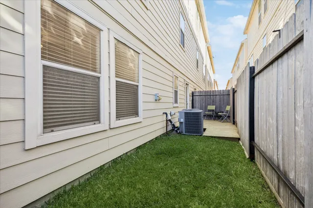 a backyard of a house with table and chairs