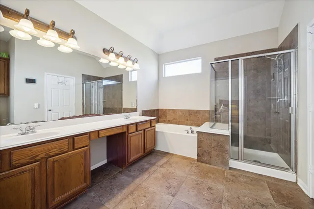 a large bathroom with a double vanity sink mirror and shower