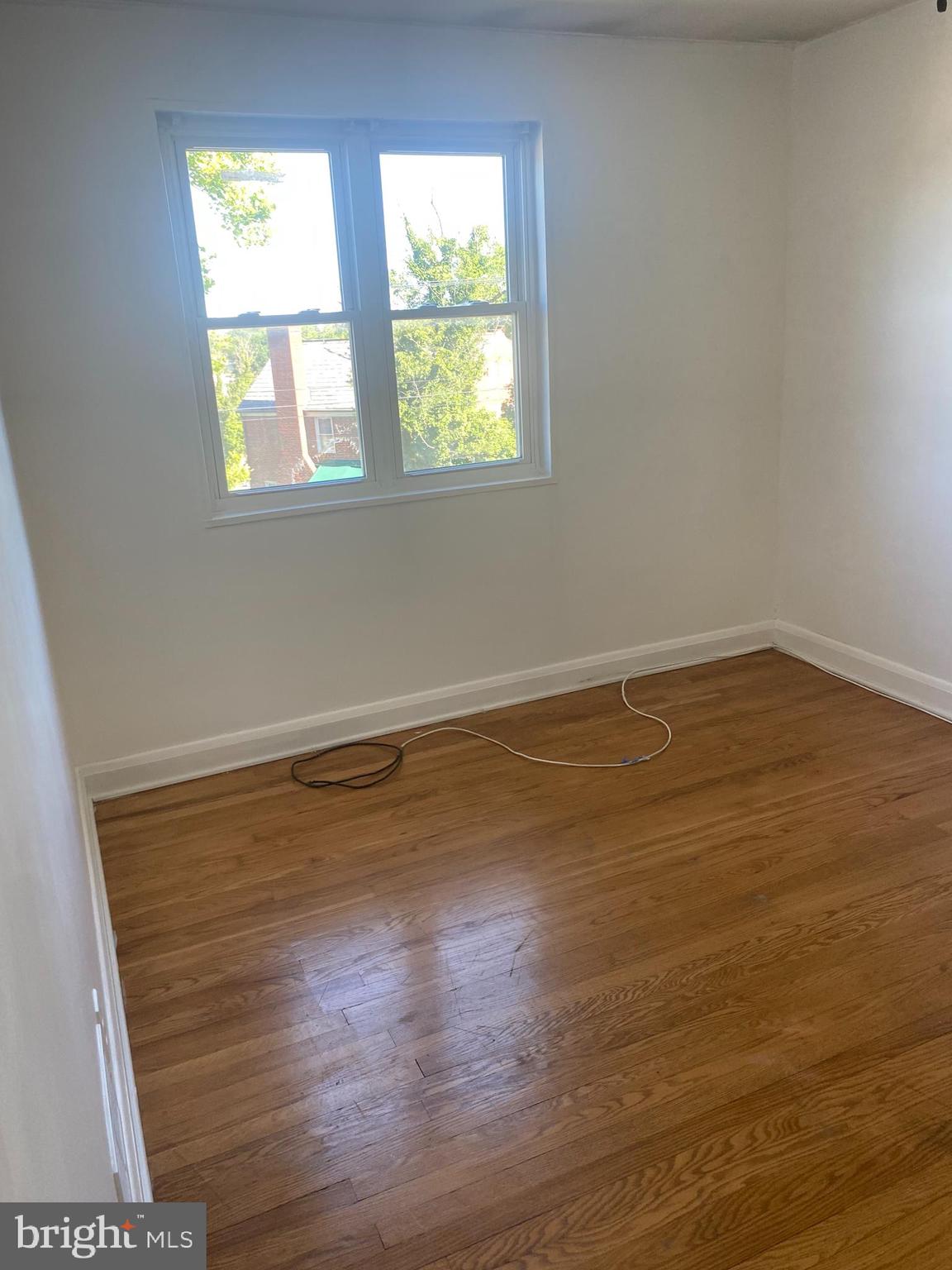 906 Masefield Road Baltimore, MD 21207 - Photo 14 of 22 wooden floor in an empty room with a window
